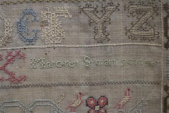 An early 19th century needlework sampler with alphabet, houses, lion, flowers and other motifs, dated 1805, 41 x 31.5cm